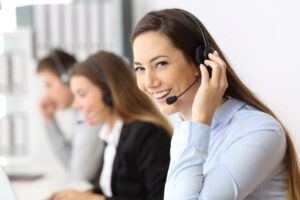 A business professional replaying a recorded call over a telephone headset.