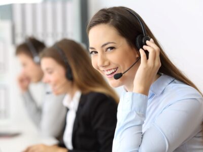 A business professional replaying a recorded call over a telephone headset.