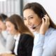 A business professional replaying a recorded call over a telephone headset.