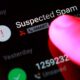 Finger pointing at suspected spam call on smartphone