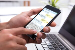 Business person sending a text message on a mobile device