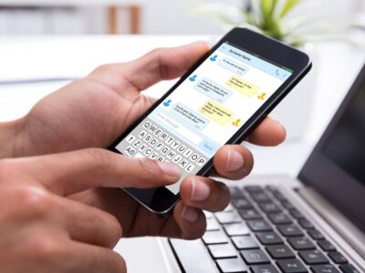 Business person sending a text message on a mobile device
