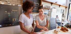 Two women working behind counter