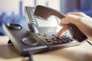 hand dialing a telephone keypad