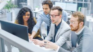 Diverse Team of Businessmen and Businesswoman Work on Computer